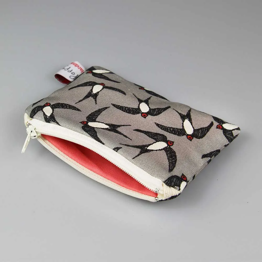 swallows small coin purse