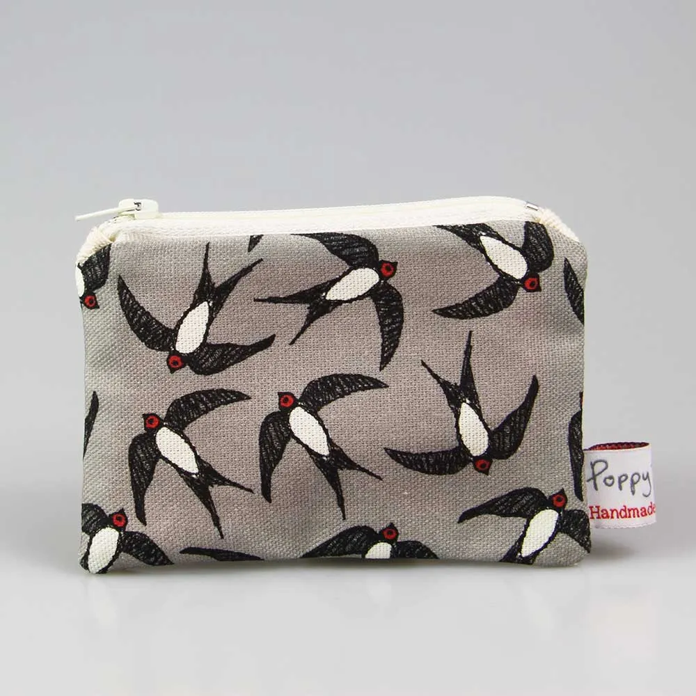 swallows small coin purse